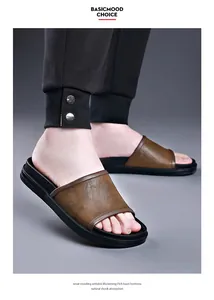 Close-up view of stylish men's brown leather slides with anti-skid black EVA foam soles.