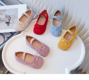 Assorted colors of girls' bowknot Mary Jane flat shoes on a white display table