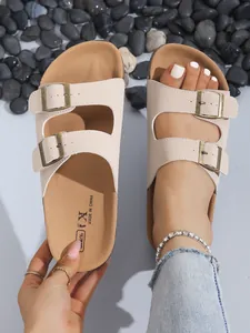 Detail view of beige platform cork sandals with double buckles for casual beach wear