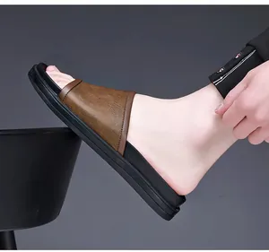 Side view detail of men's casual brown slide sandals with thick black soles for summer