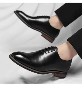 Detail view of men's black square-toe Oxford dress shoes in classic British style