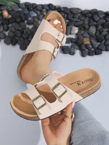 Detailed close-up of stylish beige double-buckle cork platform sandals for beach leisure