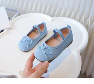 Detailed close-up of light blue girls' fabric Mary Jane shoes featuring a cute bow design