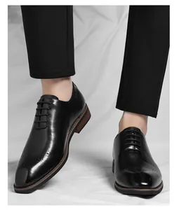 Close-up of men's black leather Oxford shoes with elegant brogue details for business wear