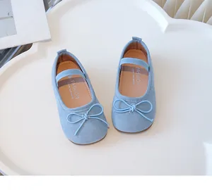 Close-up view of light blue toddler girl flat shoes with a decorative bow tie accent