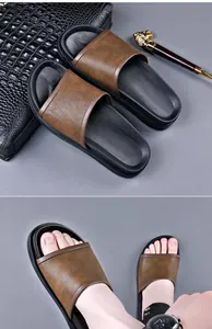 Detail view of men's brown leather slides with a black bag and on-feet perspective