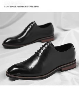 Elegant black men's Oxford dress shoes featuring intricate brogue details and leather finish