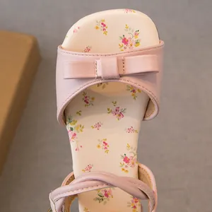Sweet pink girls' sandals featuring an elegant bow and charming floral pattern footbed