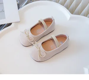Elegant beige pink girls' bow flats featuring soft soles and elastic strap detail