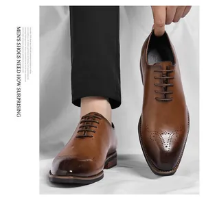 Macro view of brown leather business Oxford shoes featuring brogue perforations and square toe