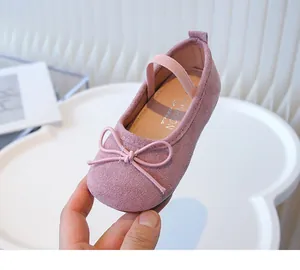 Close-up of pink girls' Mary Jane shoe featuring a cute bow and soft suede texture.