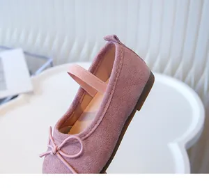 Detailed macro view of a pink toddler ballet flat shoe with decorative bow and elastic strap