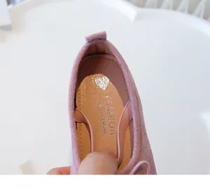 Close-up detail of the inner sole and pink suede texture of girls' ballet flats