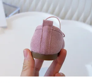 Detailed close-up showing the soft suede texture on the heel of pink girls' ballet flats