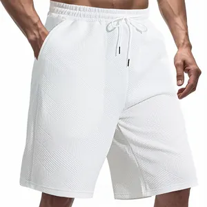Detail view of white men's shorts featuring heavy jacquard diamond texture