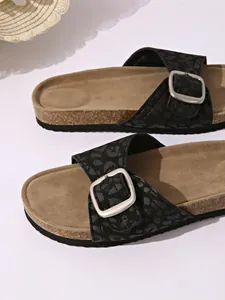 Close-up of leopard print women's slide sandals with cork sole and silver buckle