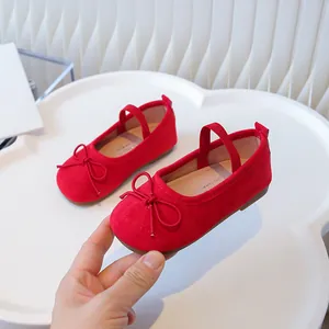 Red toddler girls soft-sole flats featuring a bow detail and secure elastic strap