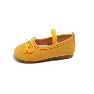 Vibrant yellow suede Mary Jane flats for girls featuring a cute bow and elastic strap