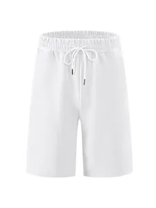 Detail of men's white jacquard texture shorts with elastic waistband and drawstring.