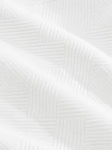 Close-up of white heavy-duty jacquard texture fabric on high-street men's shorts
