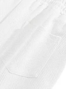 Detail view of white heavy jacquard textured fabric showing pocket stitching