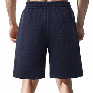 Back view of men's navy blue heavy jacquard textured shorts with an elastic waistband.