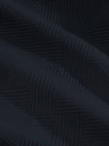 Close-up of heavy jacquard fabric texture on navy men's street style shorts.