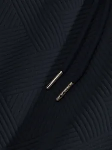 Detailed macro shot of heavy jacquard geometric texture and metal aglets