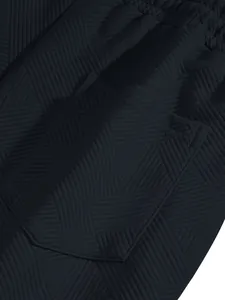 Macro detail of heavy jacquard textured fabric and side pocket on men's navy high street shorts