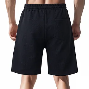 Rear view of black jacquard textured men's shorts showing premium woven fabric detail.