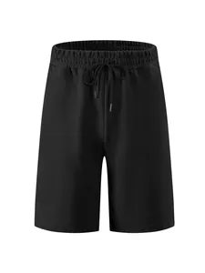 Detailed view of men's high-street black shorts featuring heavy jacquard texture and drawstring.