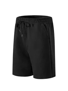 Close-up of men's black shorts featuring heavy jacquard texture and drawstring waist