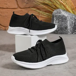 Detailansicht schwarzer Flying Knit Sneaker mit dicker weißer Plateausohle.