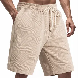 Close-up detail of heavy jacquard texture on men's loose beige summer casual shorts