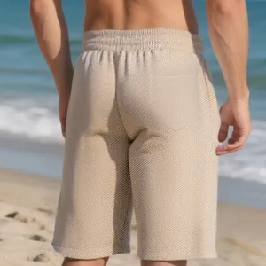 Detailed macro view of the heavy jacquard texture on men's trendy summer beach shorts