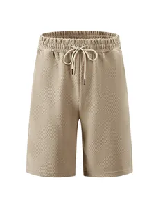 Close-up of khaki jacquard textured shorts showing detailed geometric pattern