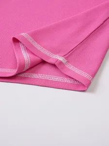 Detailed close-up of pink seersucker fabric texture and white contrast stitching on men's top