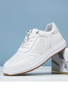 Side detail of white breathable leather sneaker with perforated pattern
