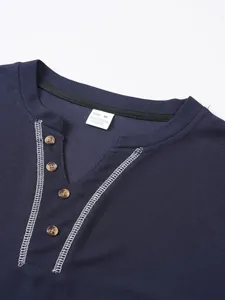Detail of navy Henley collar featuring contrast stitching and waffle texture fabric
