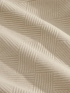 Close-up of heavy jacquard texture fabric on men's high street fashion shorts.
