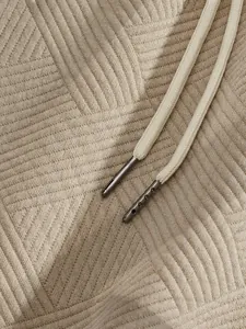 Detailed macro shot of heavy jacquard fabric texture and drawstring with metal aglets