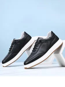 Detailed macro view showing the textured black leather and breathable perforations of men's casual shoes