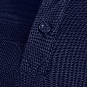 Close-up of navy blue pique fabric texture and button detail on a men's polo shirt.