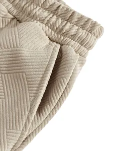 Detailed macro shot of the heavy jacquard fabric texture on beige men's casual shorts