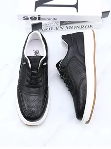 Detailed view of premium black breathable leather sneakers featuring perforated patterns
