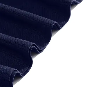 Macro view of navy blue pique knit fabric showing breathable texture detail for polo shirt