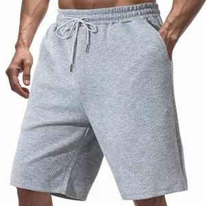 Close-up detail of grey men's summer shorts showing unique jacquard texture pattern