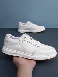 Macro view of white first-layer cowhide leather sneaker featuring a textured finish
