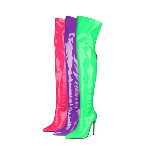 Detailed view of neon patent leather over-the-knee boots in pink, purple, and green