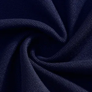Macro detail of breathable quick-dry mesh fabric for navy blue men's polo shirt.